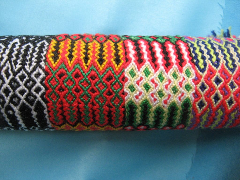 Pile of makrame bracelets in many colors and patterns