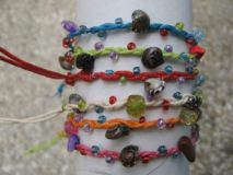 String braided with beads, shells and gems